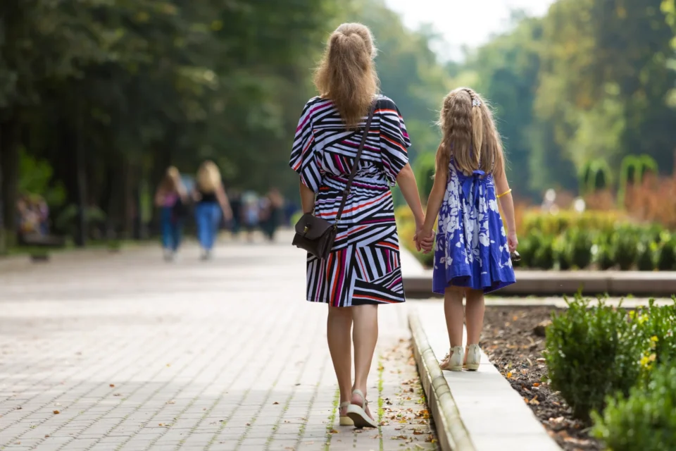 Mother with a daughter walking in a park in Minsk